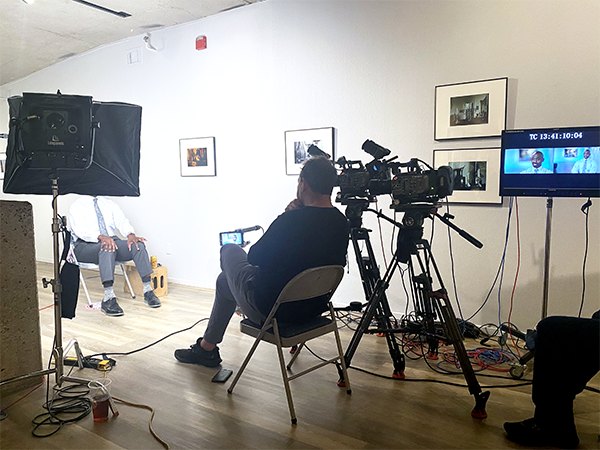 Camera crew filming an interview setup