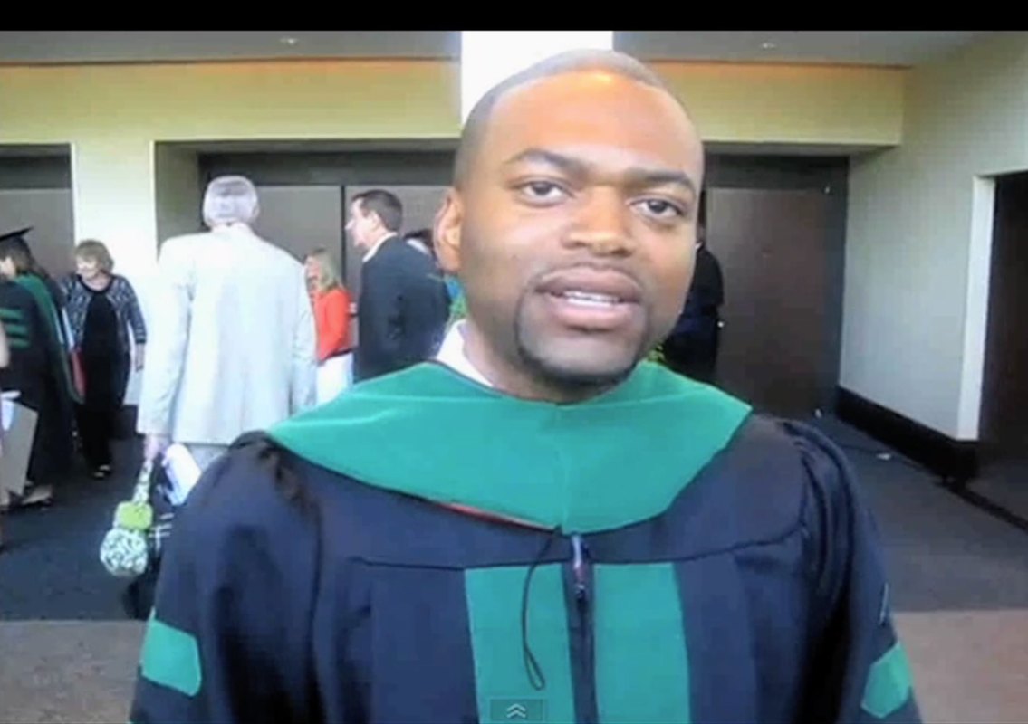 Black medical school graduate in academic regalia